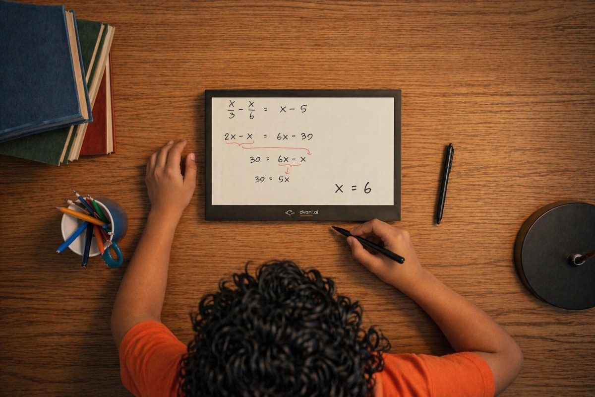 A child's hands working on the page, seen from above